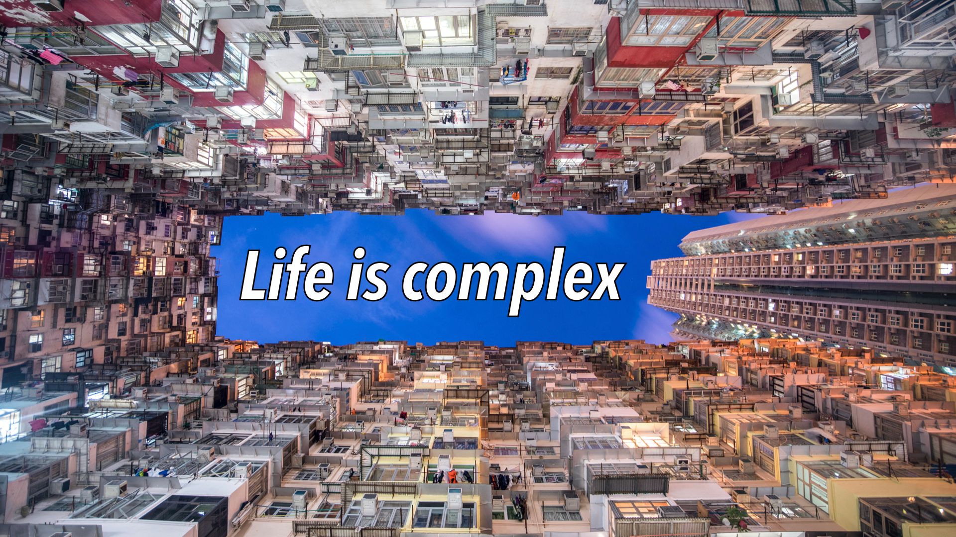 Slide text "Life is complex" overlaid on blue sky surrounded by high-rise apartment blocks